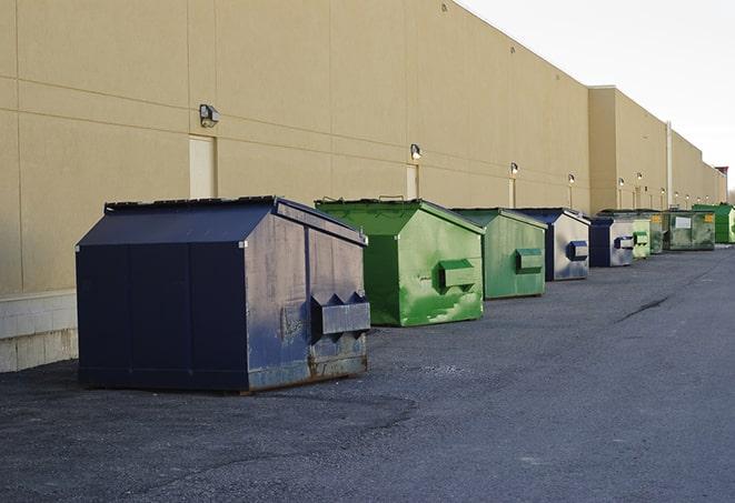 multiple construction dumpsters at a worksite holding various types of debris in Burlington, CT